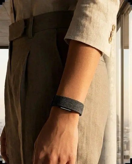 Hume Health Band worn on the wrist beneath a linen sleeve — metabolic capacity tracking during everyday life