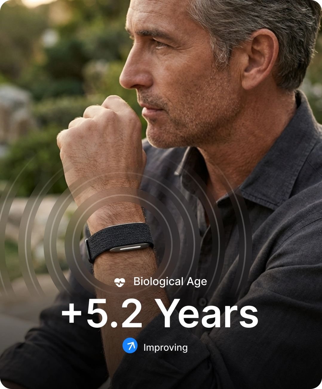 Man wearing the Hume Health Band with biological age and chronic illness risk shown in app
