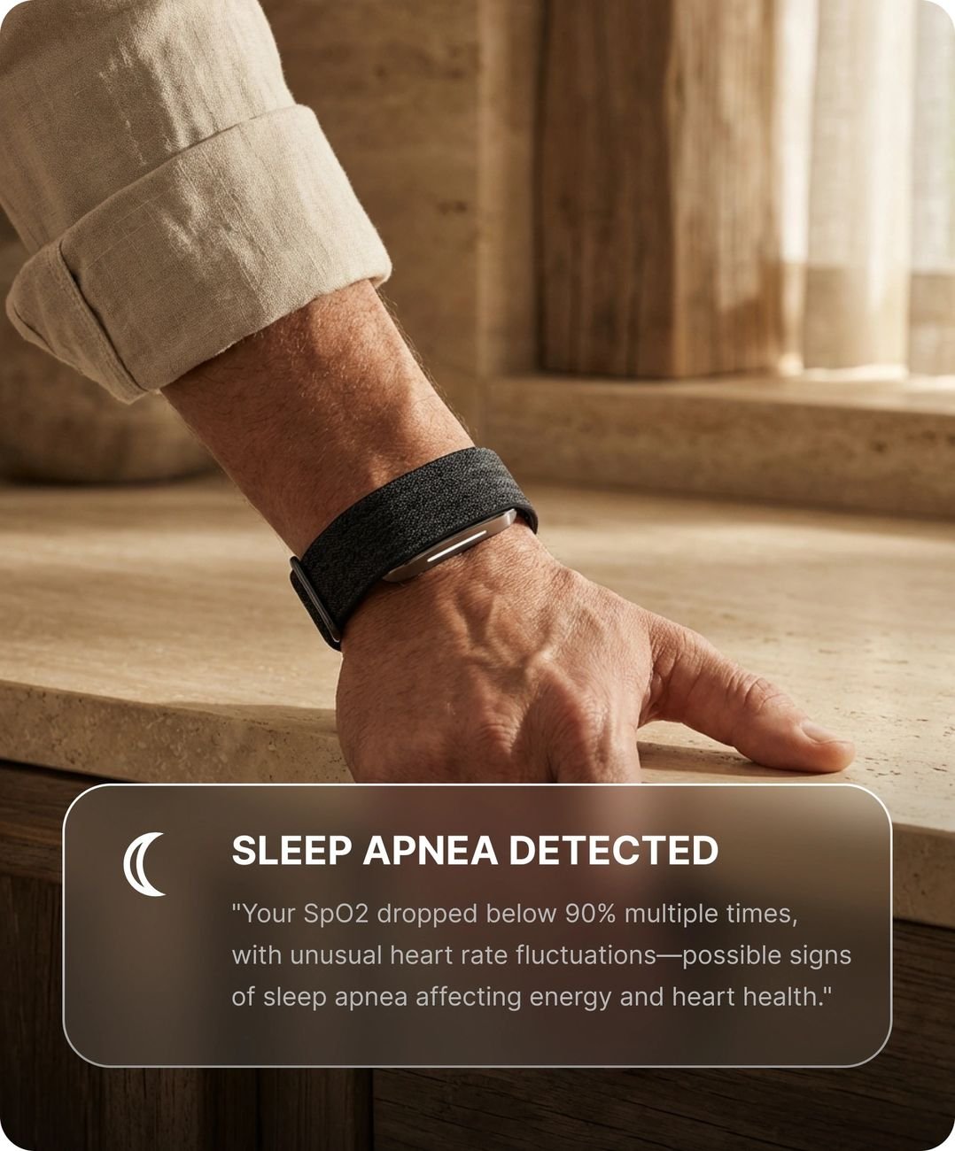 Hume Health Band on wrist with a sleep apnea alert shown in the companion app