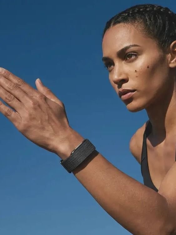 Athletic woman wearing the Hume Health Band outdoors — building metabolic momentum